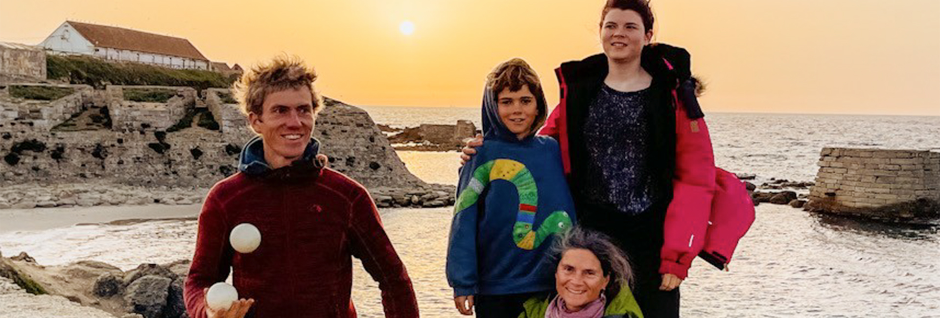 Nirmala and her family at the meeting point of the Mediterranean Sea and the Atlantic Ocean in southern Spain at sunset.