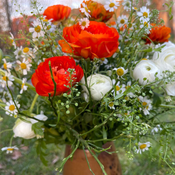 Bouquet of orange and white ranunculus, with small white flowers - decorative, fresh, aesthetic